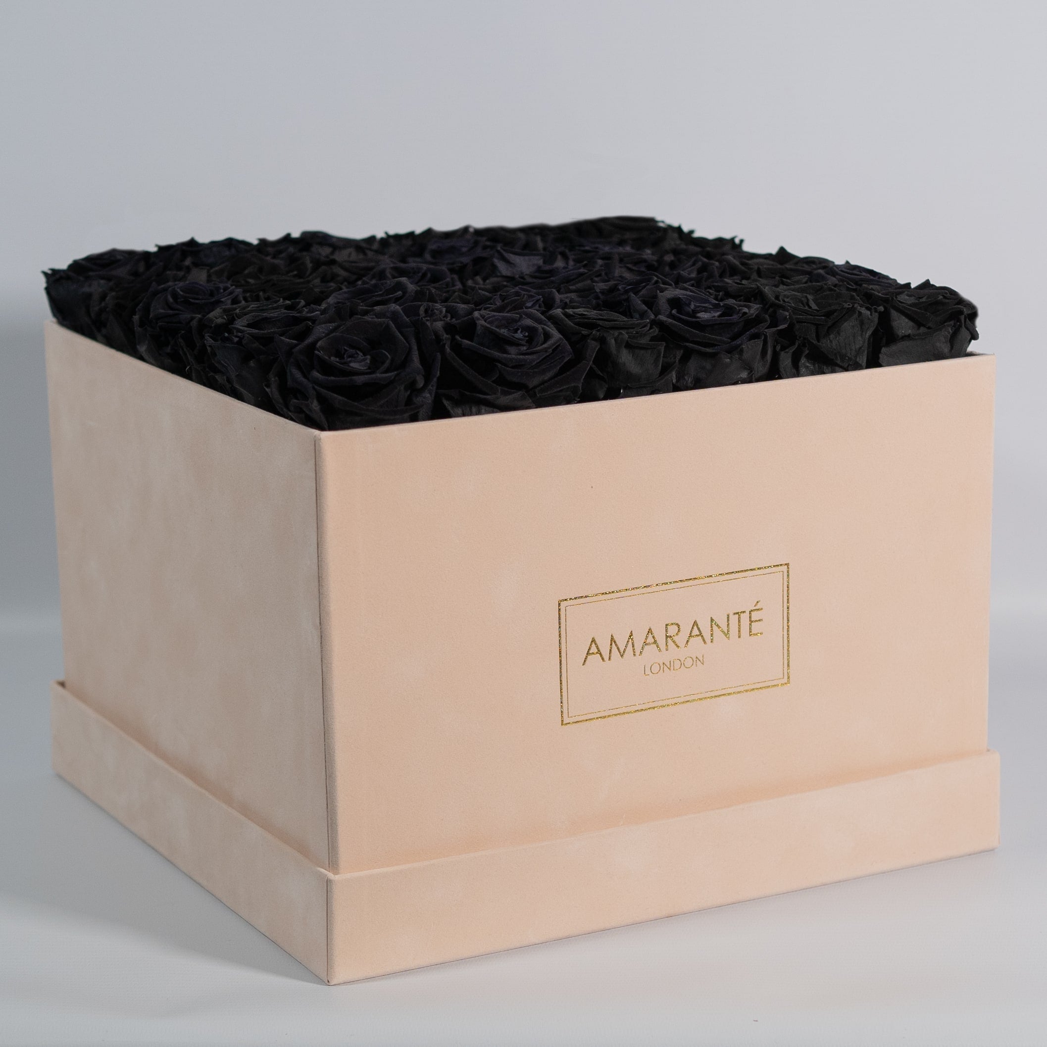 Dapper black Roses in an elegant beige box. 