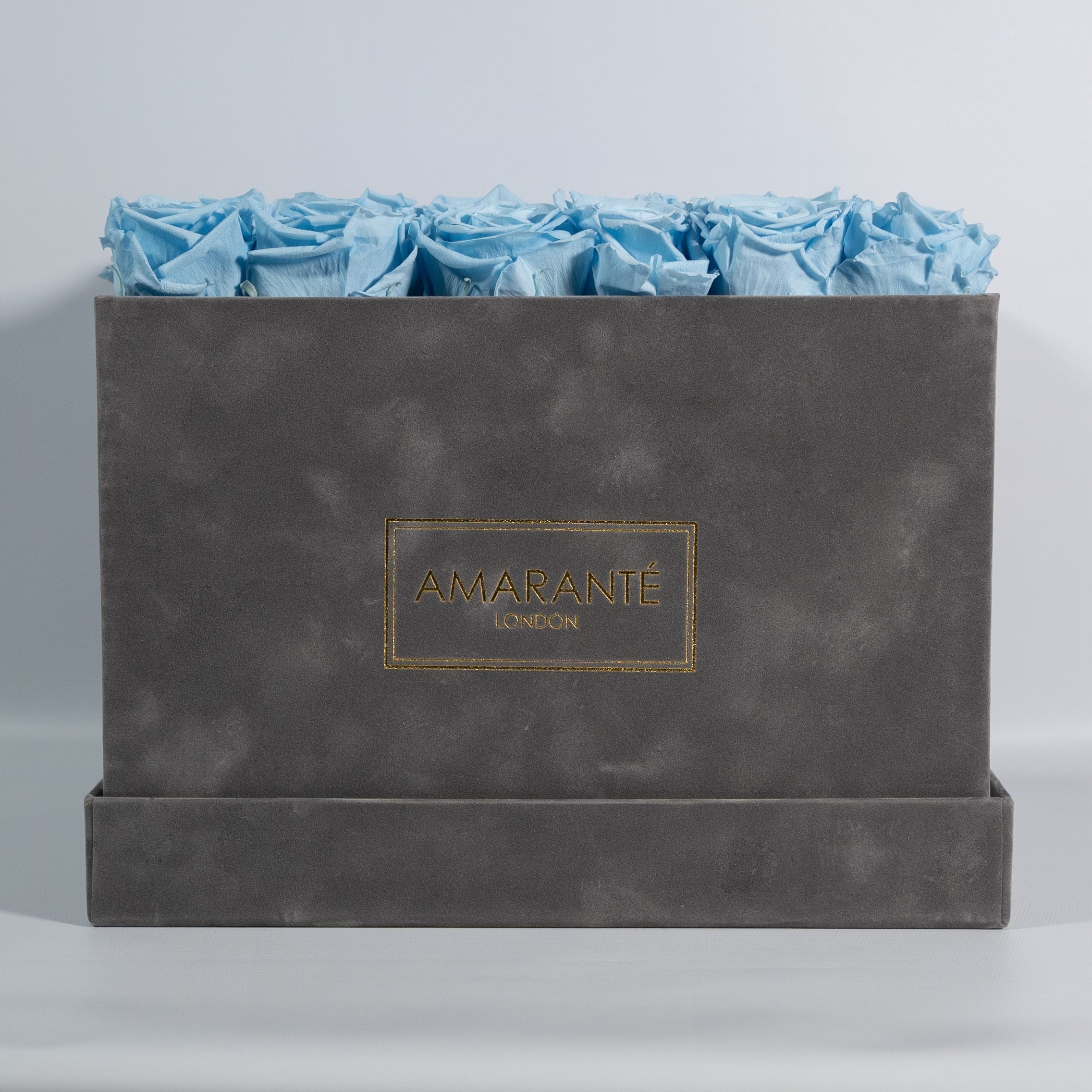 Dapper light blue Roses in a stylish grey package 