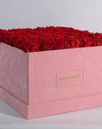 Divine red roses in a blushing pink suede extra large box 