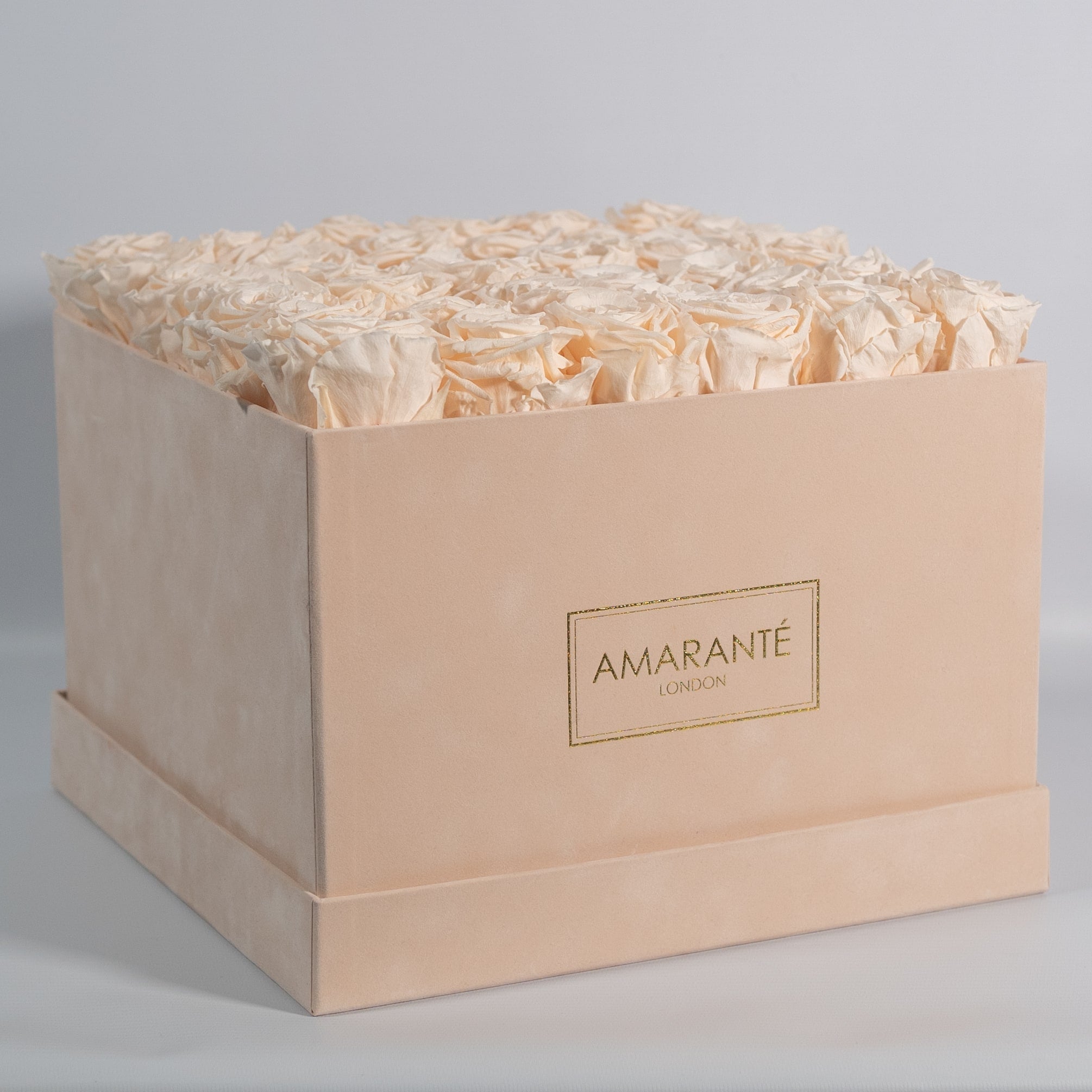 Classic champagne Roses in a magical beige box, connoting endless love.