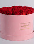 Divine red Roses shown in a magical pink suede box