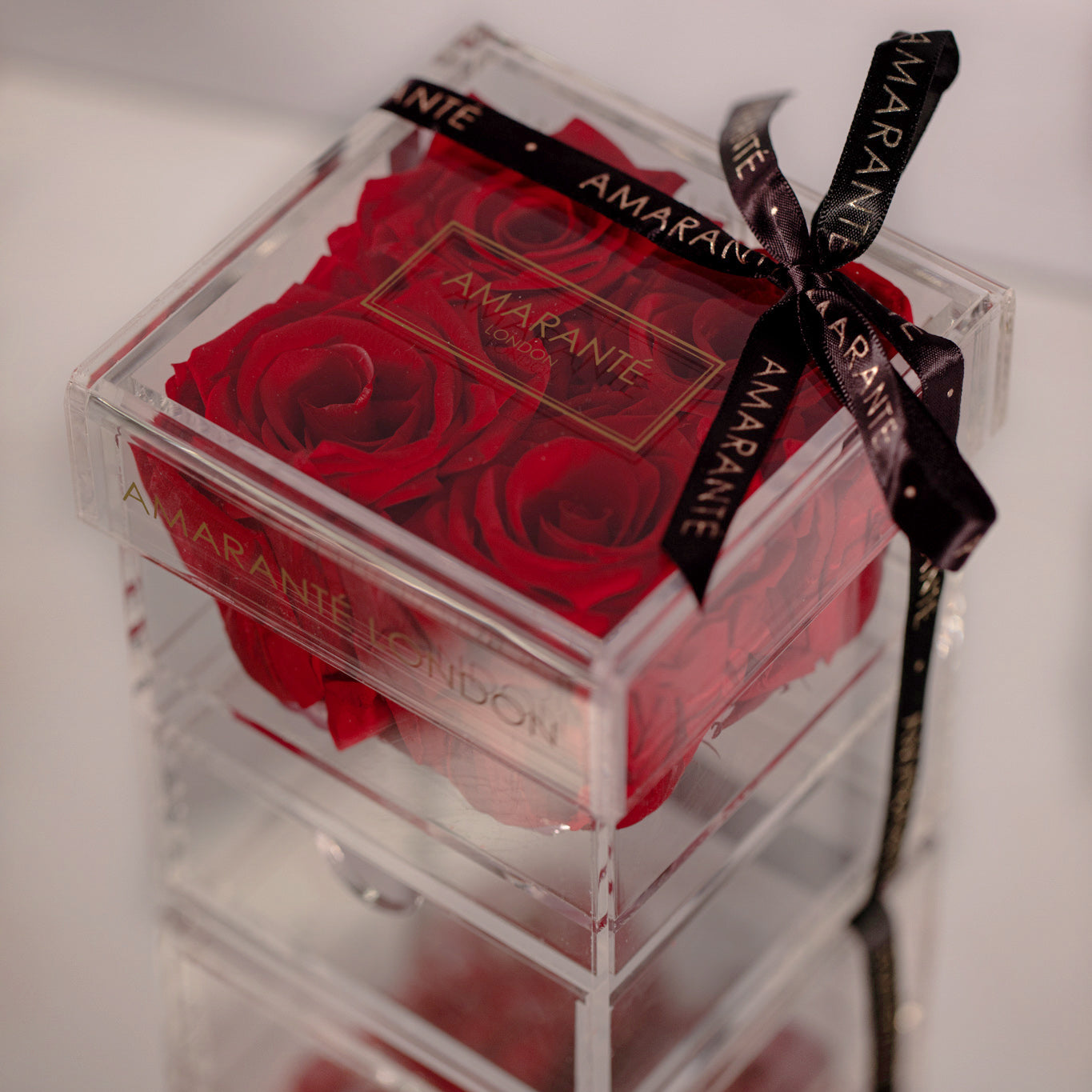 Dreamy red roses in set of four featured in a small acrylic box 