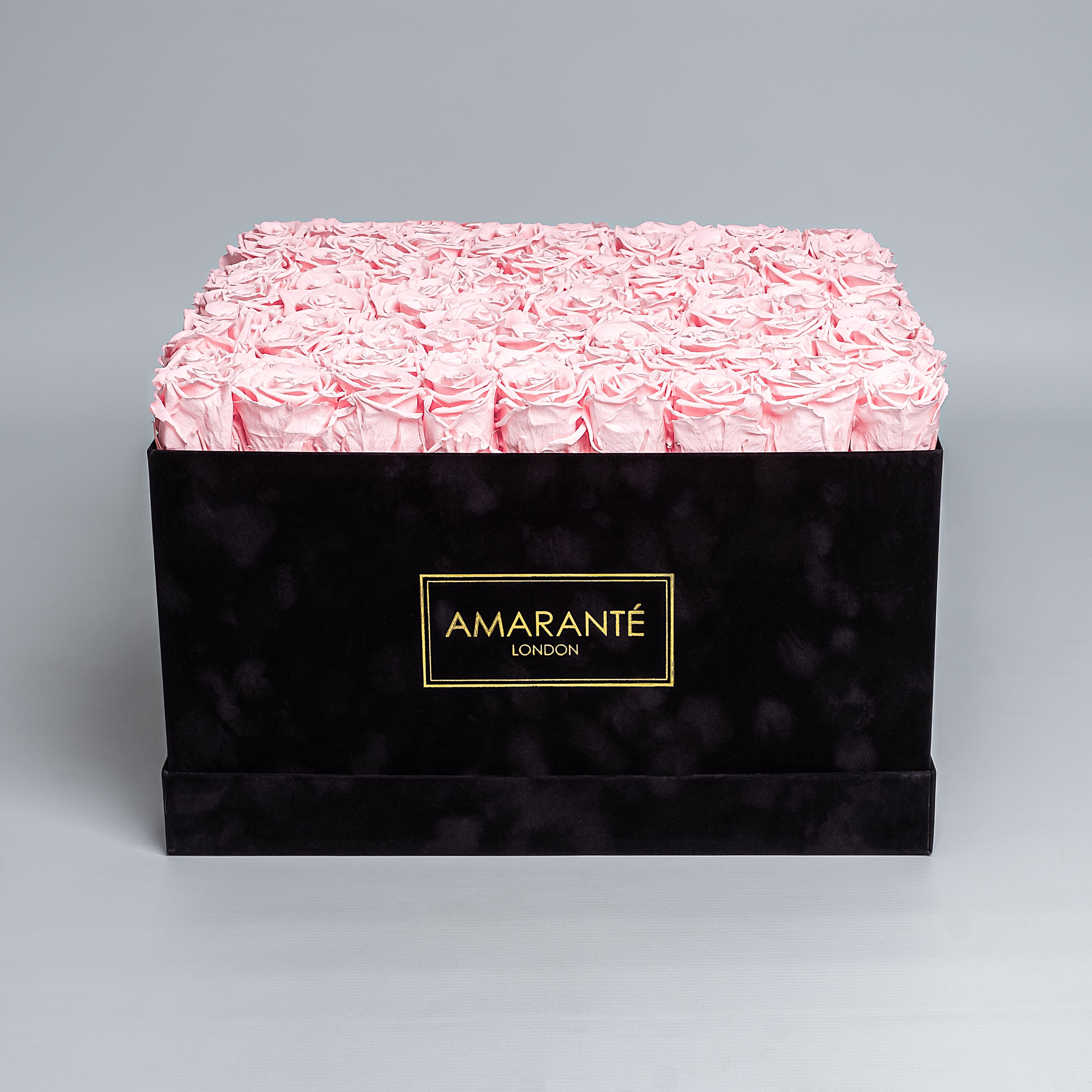 Luxurious 16"x16" black square rose box of pink everlasting roses with an elegant suede finish, offering free UK delivery. Choose from a palette of 14 delicate pastel colours.