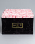 Luxurious 16"x16" black square rose box of pink everlasting roses with an elegant suede finish, offering free UK delivery. Choose from a palette of 14 delicate pastel colours.