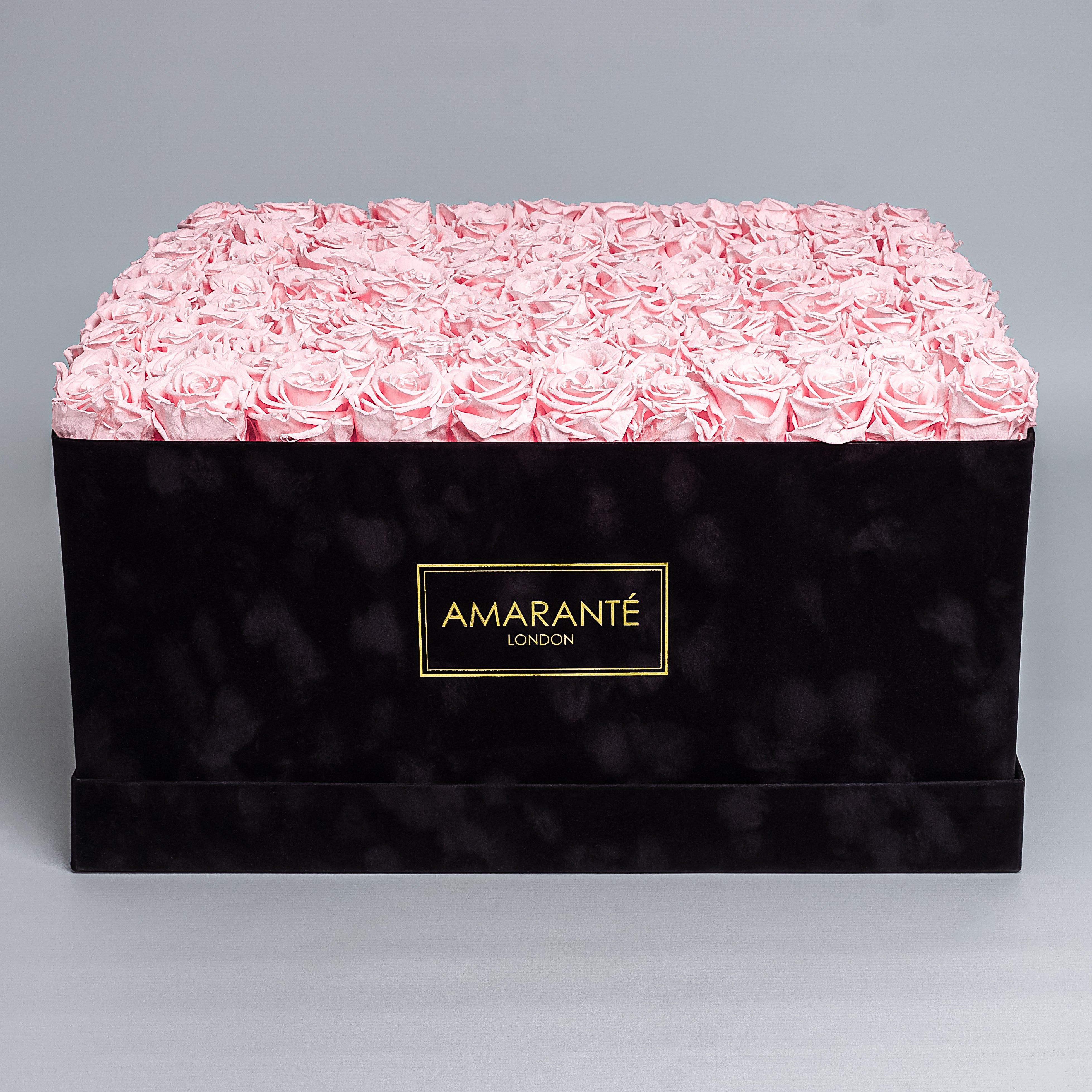 Elegant super deluxe black square hatbox containing 150 light-pink forever roses, epitomising timeless romance. Free UK delivery. Each rose 2-3 inches, box size  20"x20".
