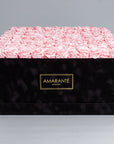 Elegant super deluxe black square hatbox containing 150 light-pink forever roses, epitomising timeless romance. Free UK delivery. Each rose 2-3 inches, box size  20"x20".