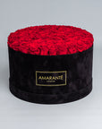 70 Exquisite bright red infinity roses elegantly arranged in a stylish black deluxe suede round rose box. Perfect for expressing timeless love and affection to family, friends and loved ones. Available for free UK delivery.