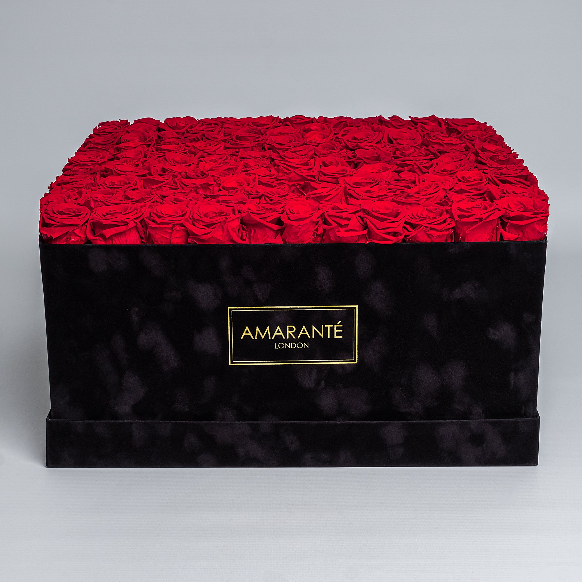 Elegant super deluxe black 20"x20" square hatbox containing 150 large red forever roses, 2-3 inches wide, available in 14 customisable colours.