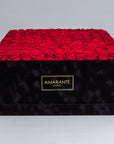 Elegant super deluxe black 20"x20" square hatbox containing 150 large red forever roses, 2-3 inches wide, available in 14 customisable colours.