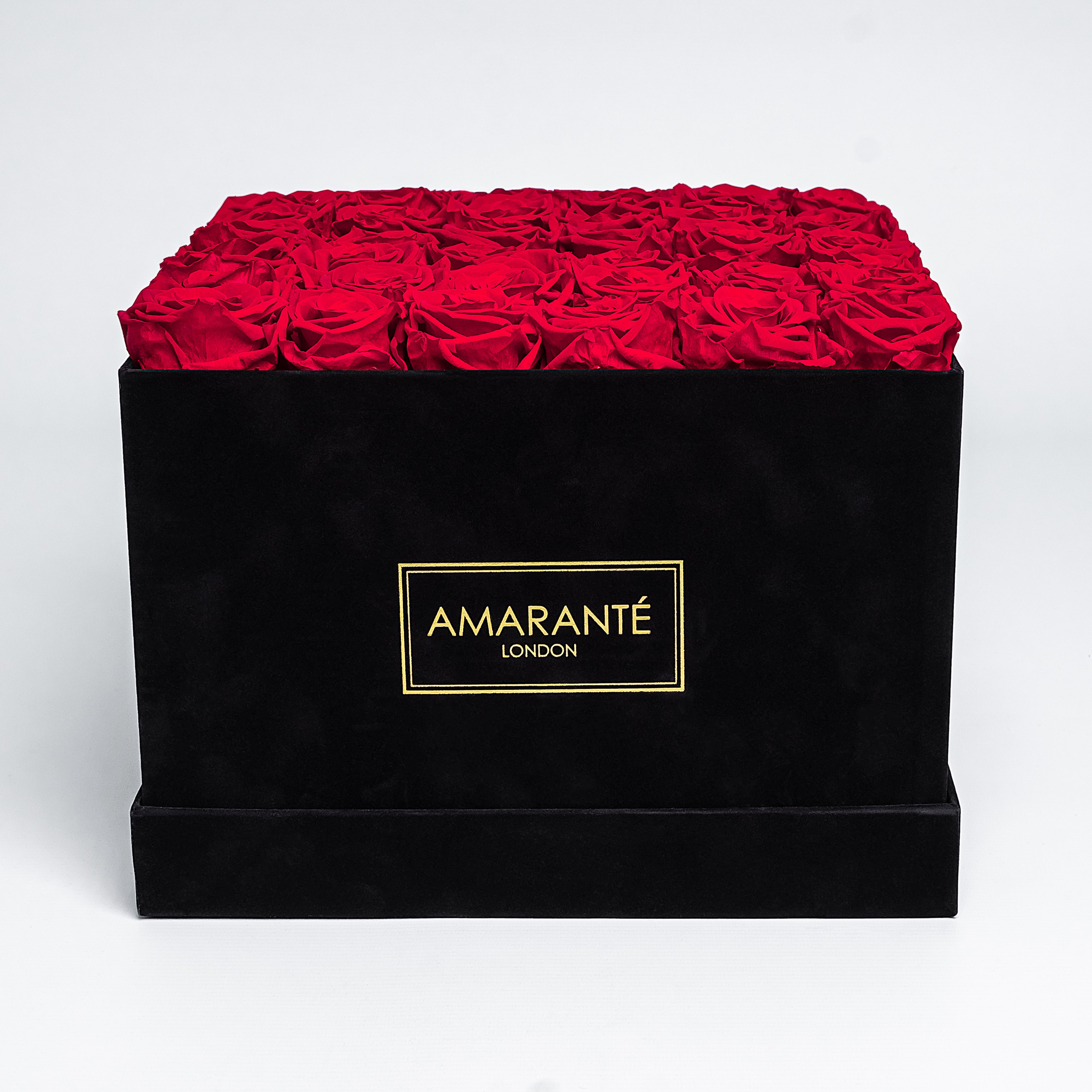 36 Bright red infinity roses elegantly placed in an extra large black suede hatbox. Free UK Delivery.