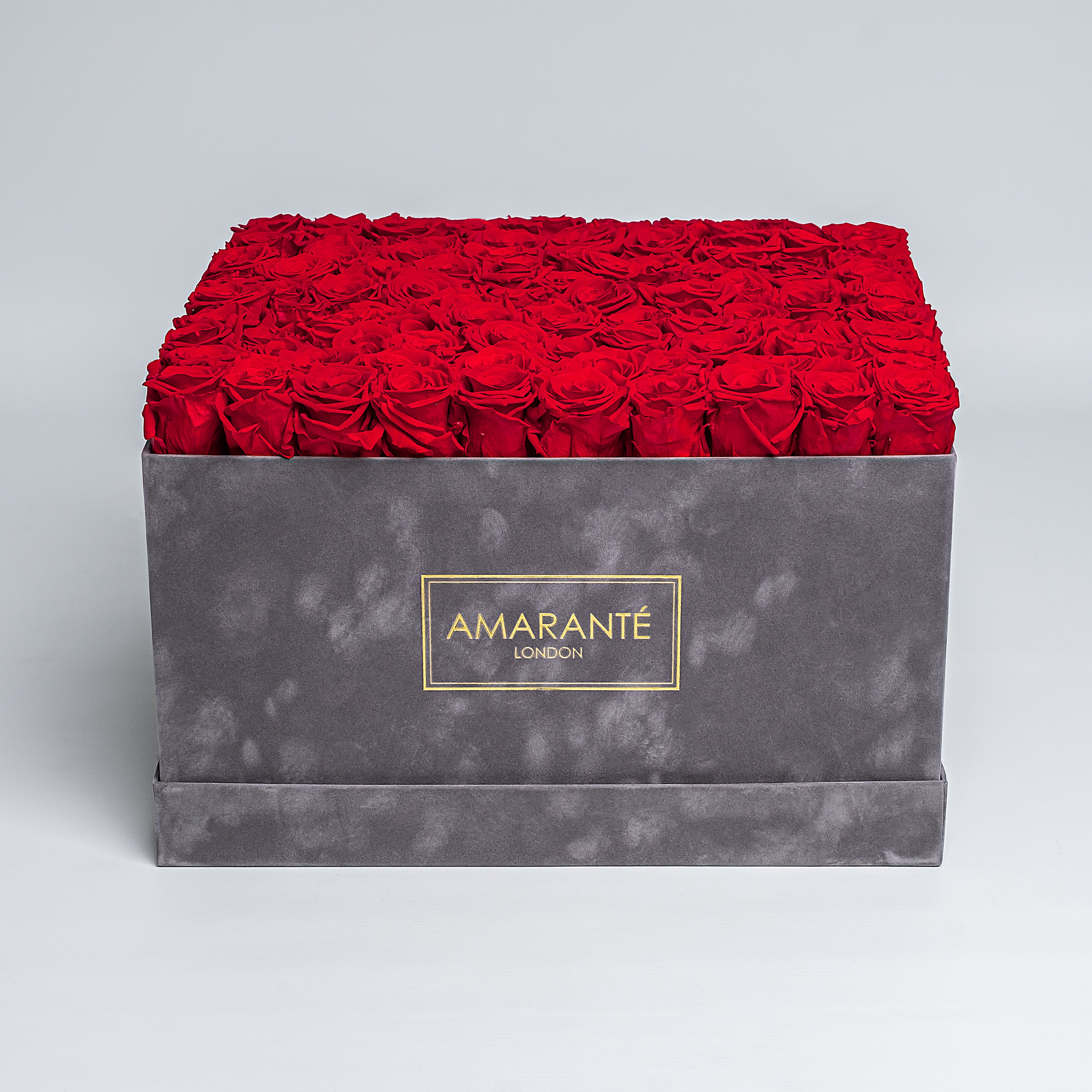 Extra large grey square suede hatbox with 100 red infinity roses for a luxurious statement of love, with free UK delivery. Elegantly crafted, 16&quot;x16&quot; rose box, infinity roses a choice of 14 delicate pastel colours.