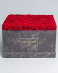 Extra large grey square suede hatbox with 100 red infinity roses for a luxurious statement of love, with free UK delivery. Elegantly crafted, 16"x16" rose box, infinity roses a choice of 14 delicate pastel colours.