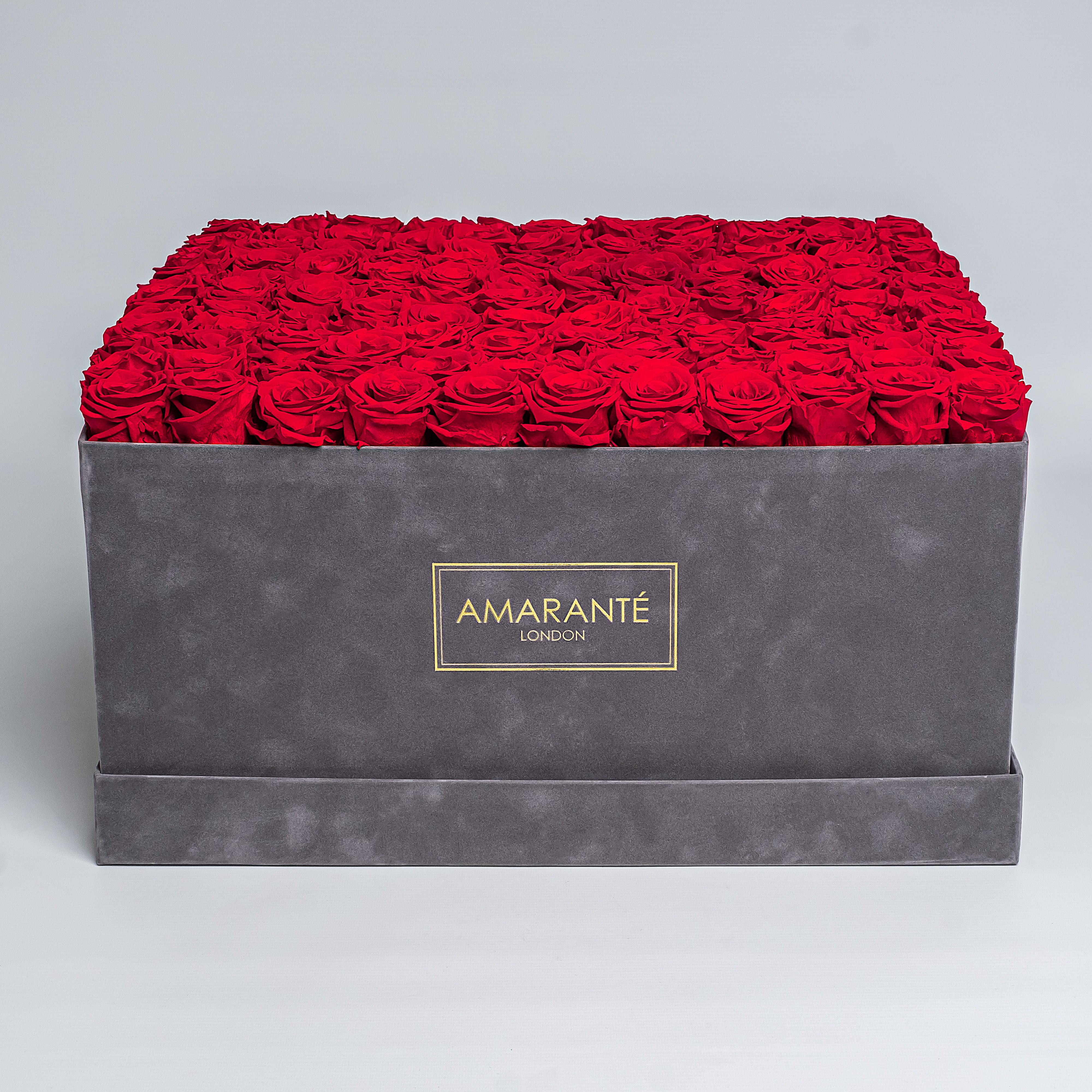 Exquisite grey suede square 20"x20" hatbox with 150 large red infinity roses, with the option to personalise your roses in other 14 delicate pastel shades, free UK delivery.