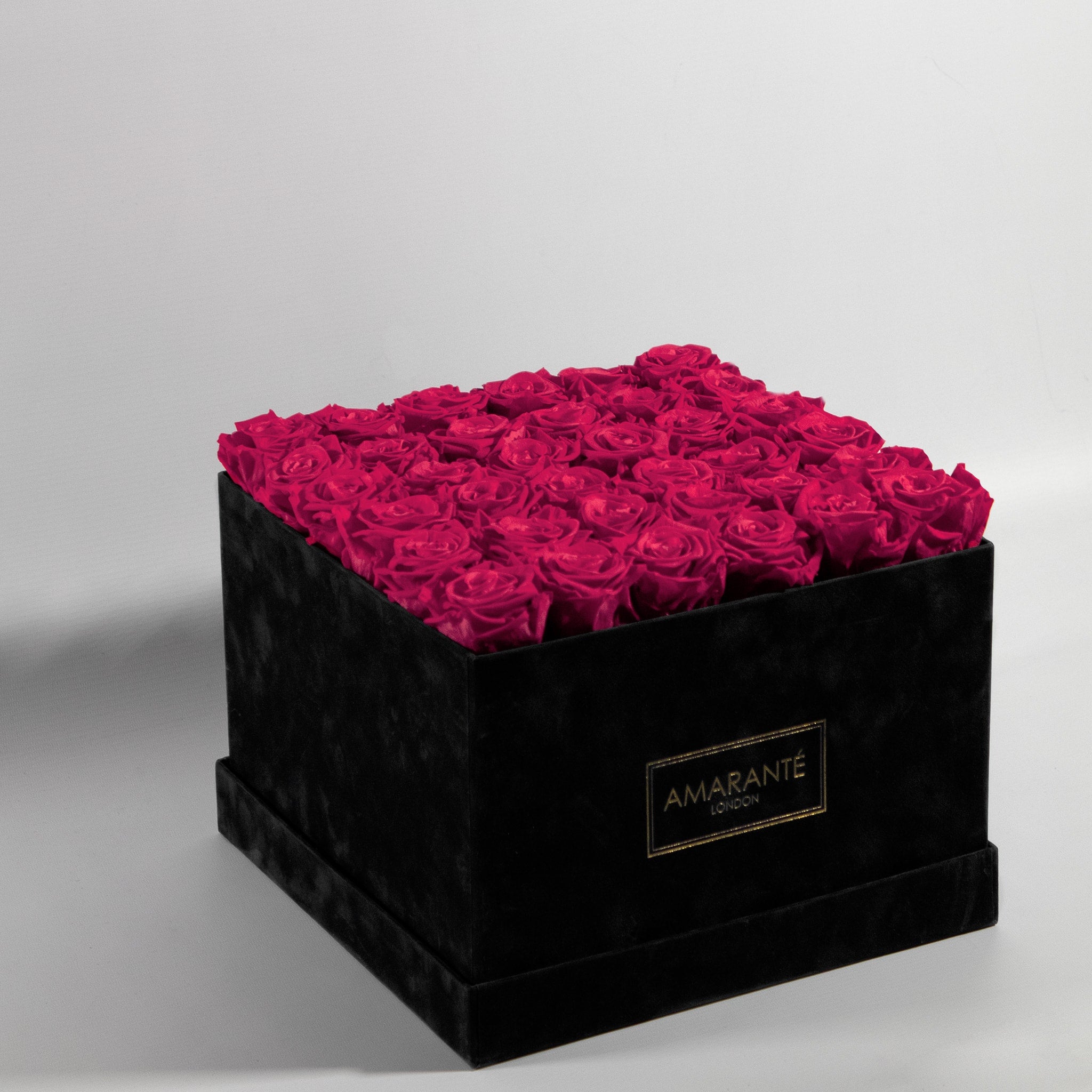 Enduring beauty of 36 captivating hot pink infinity roses in a trendy and luxurious black suede rose box.