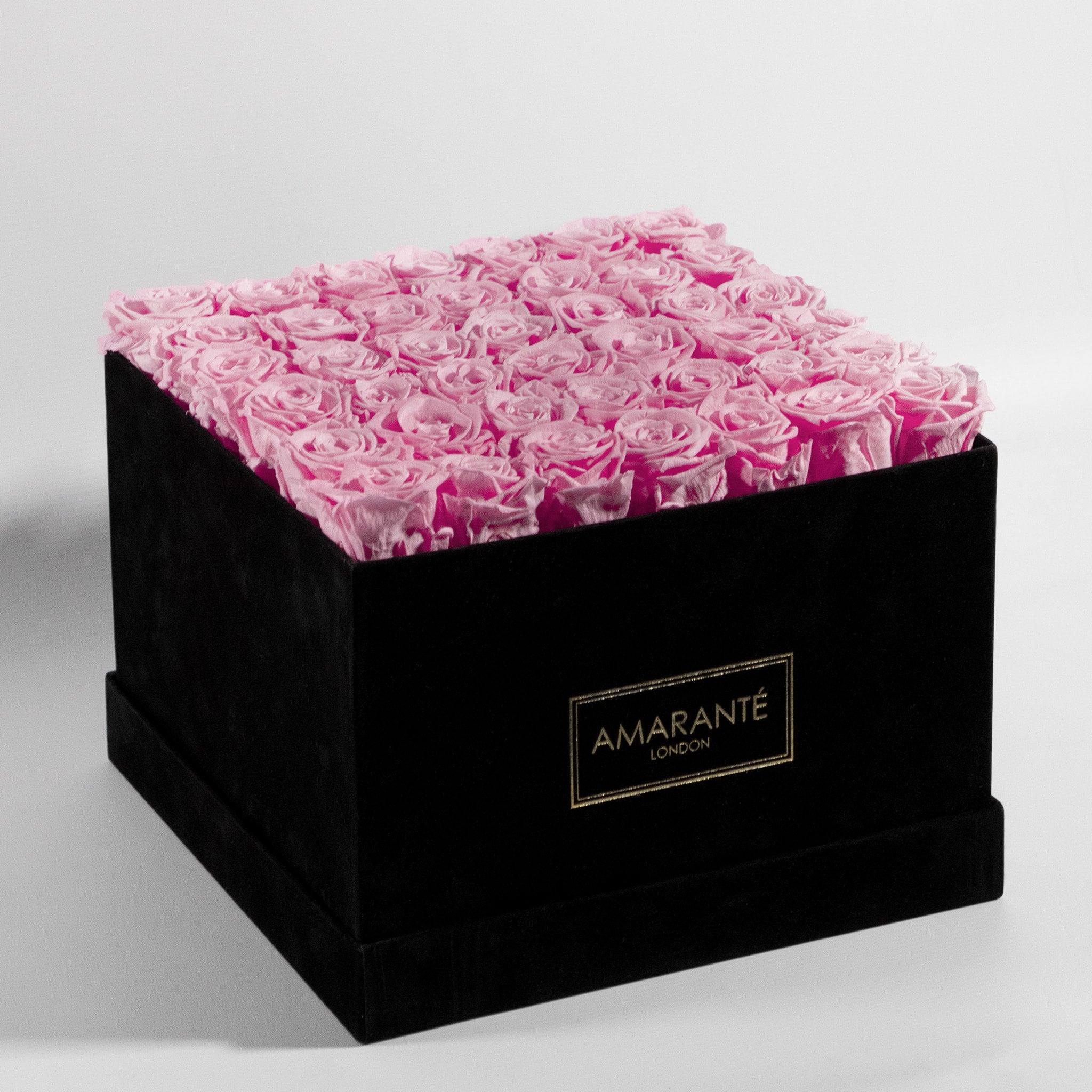 Gift of 36 enchanting pink infinity roses in a stylish black suede hatbox with Free UK Delivery.