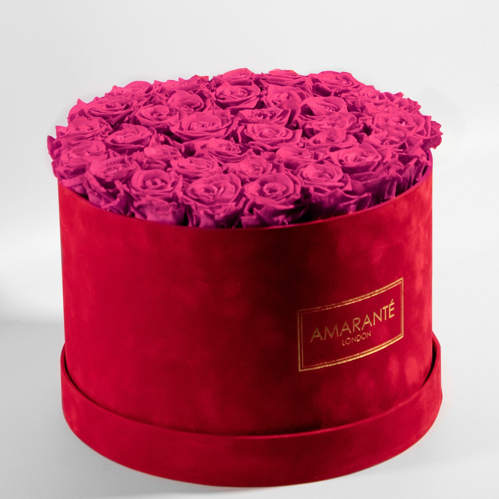 Enchanting hot pink roses accessible in a modern red box, great for expressing care, sympathy, and playfulness. 