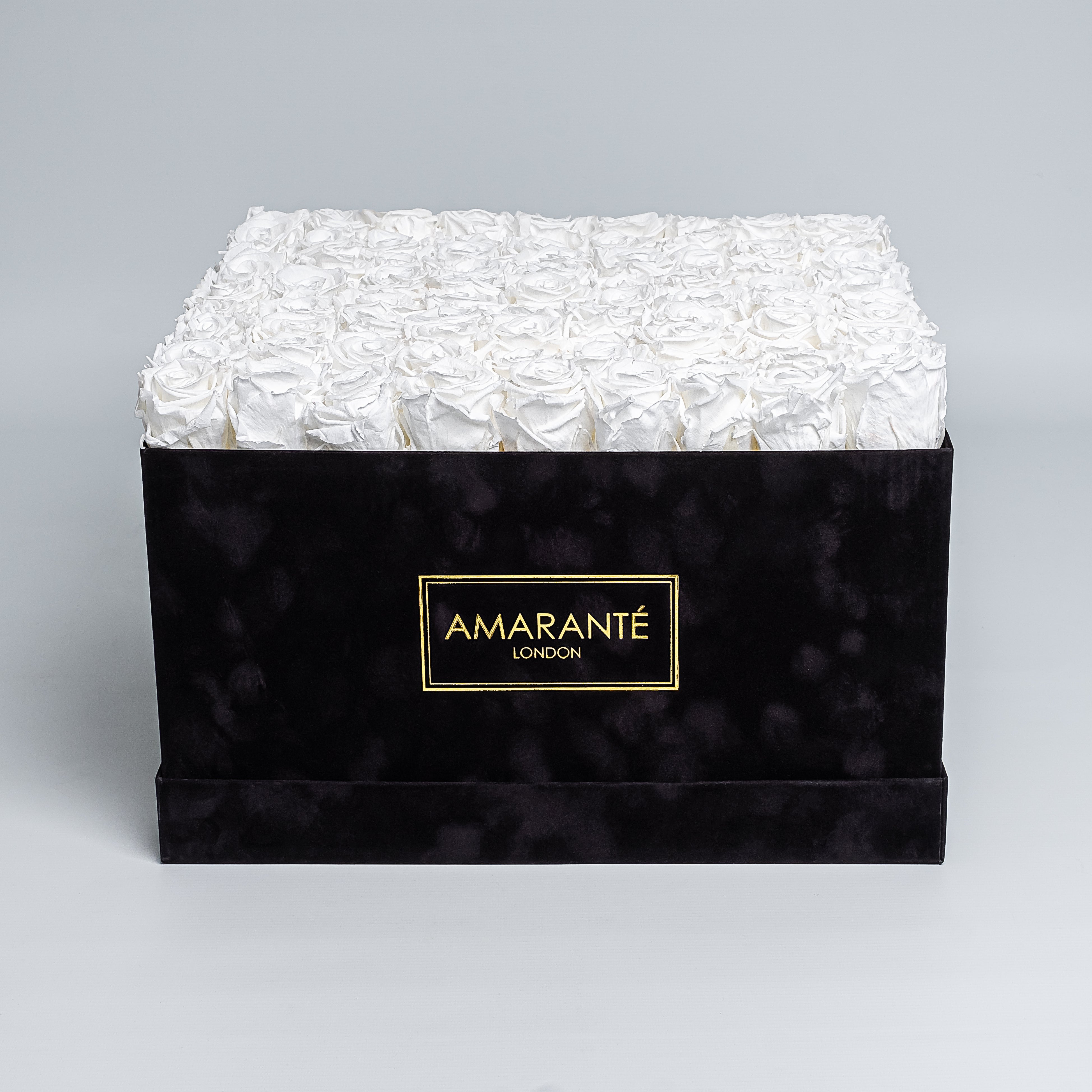 Luxurious black square rose box with suede finish, containing a hundred white infinity roses, perfect for love gestures. Free UK delivery, 16&quot; size,