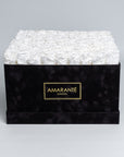 Luxurious black square rose box with suede finish, containing a hundred white infinity roses, perfect for love gestures. Free UK delivery, 16" size,