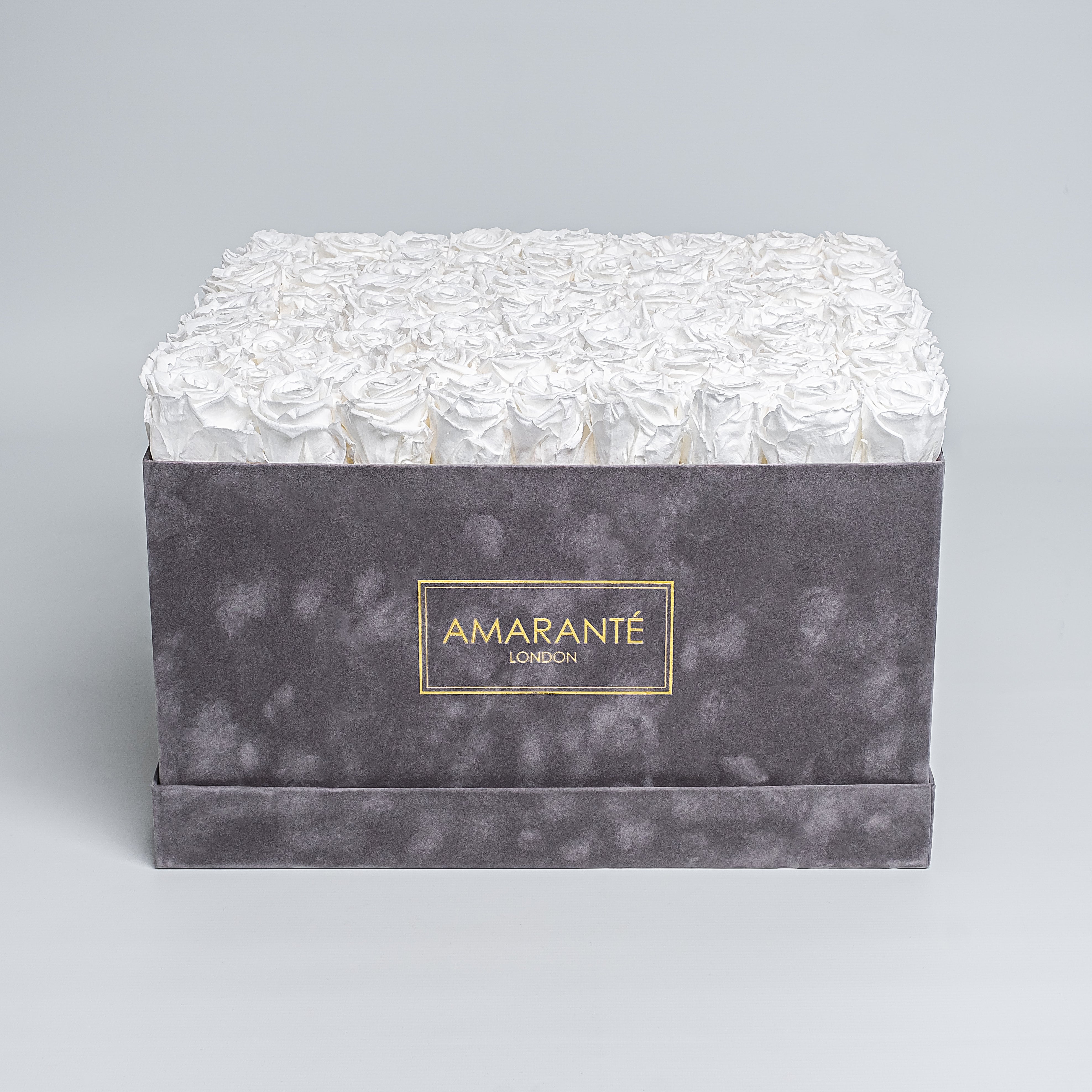 Elegant extra large grey suede hatbox with 100 large white infinity roses, a symbol of enduring love. Rose Box dimensions are 16&quot;x16&quot;, with free UK delivery, choose your infinity roses from 14 exquisite colours - Amaranté London.