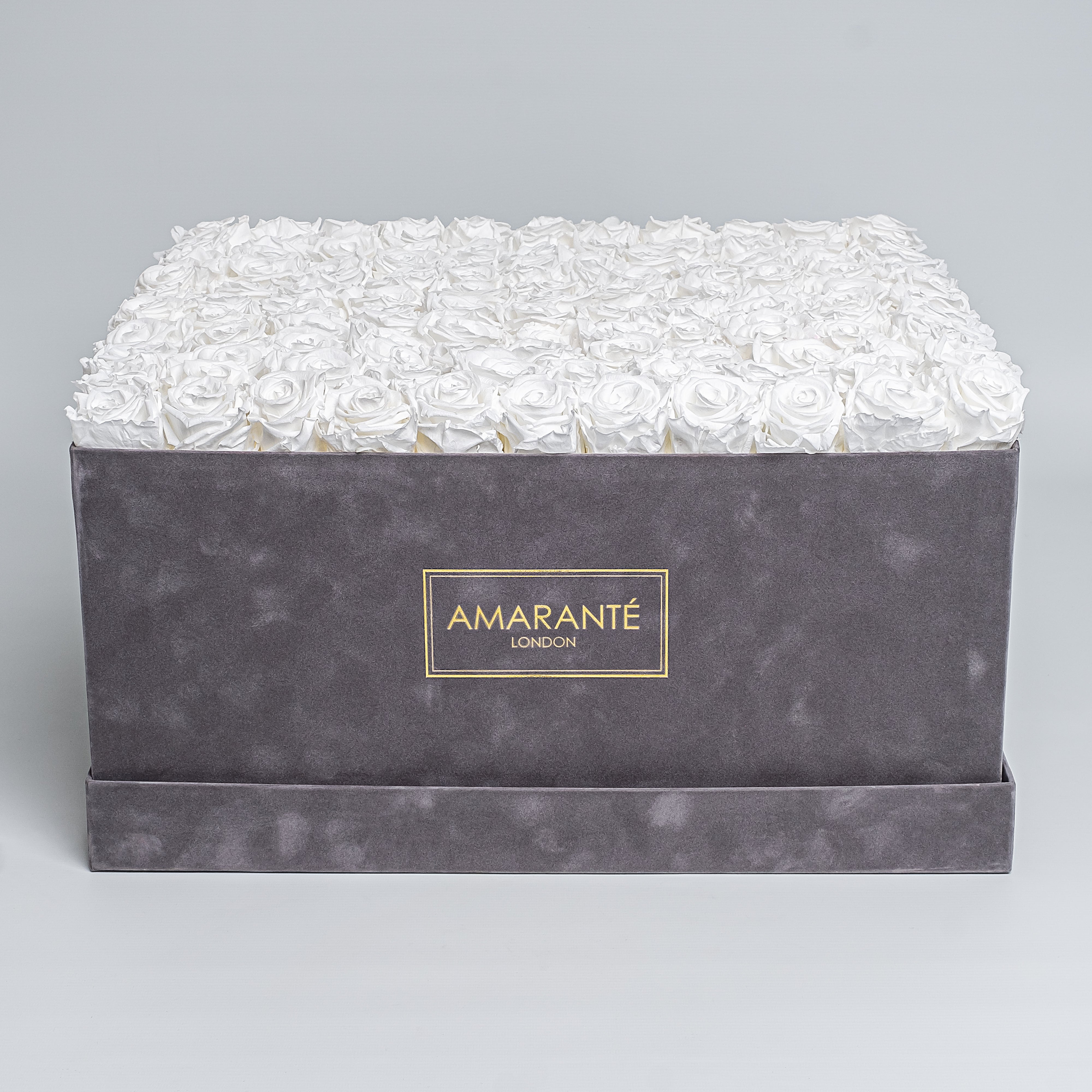 Super deluxe grey square suede rose box with 150 enchanting white infinity roses, a chic and timeless token of love - free UK delivery. Elegant rose box, 20"x20" size. Roses are also available on other 14 delicate pastel colours.