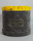 Warm yellow Roses presented in a modern grey large box 