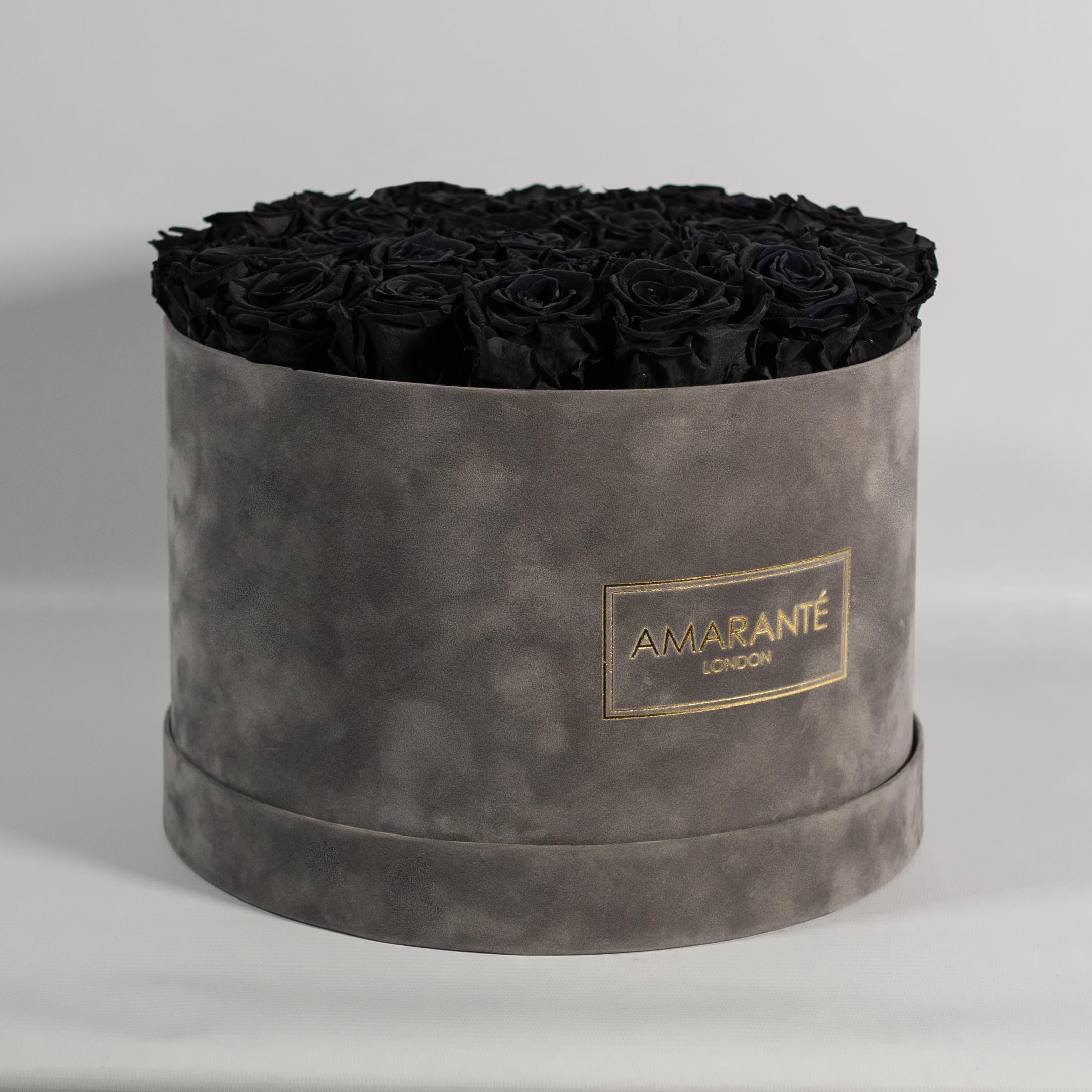 Dapper black Roses in a bold grey package.