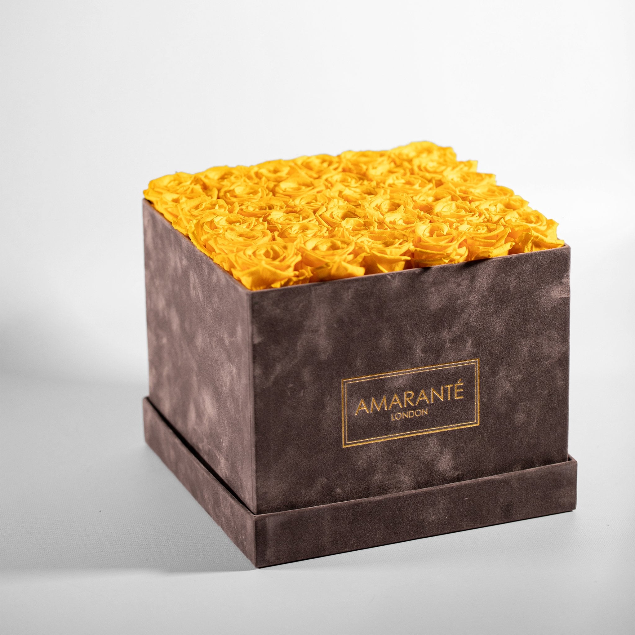 Delightful yellow Roses included in a dapper ash grey box 