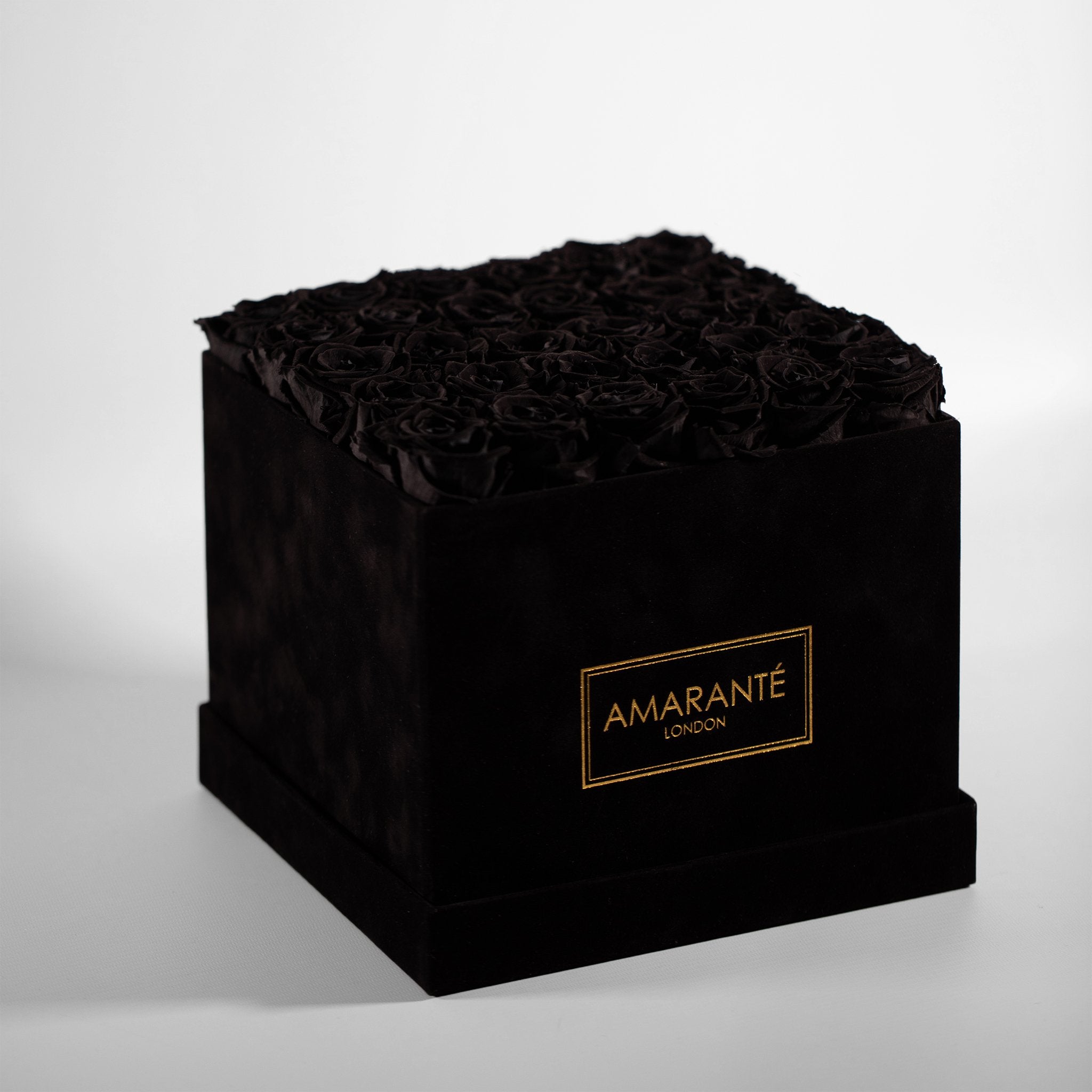 Bold black Roses comprised in a stylish black square large box. 