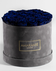 Dreamy royal blue Roses accessible in a large round grey box 