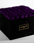 Timeless elegance captured by exquisite large purple forever roses in a chic black hatbox with elegant suede finish. Free UK Delivery.