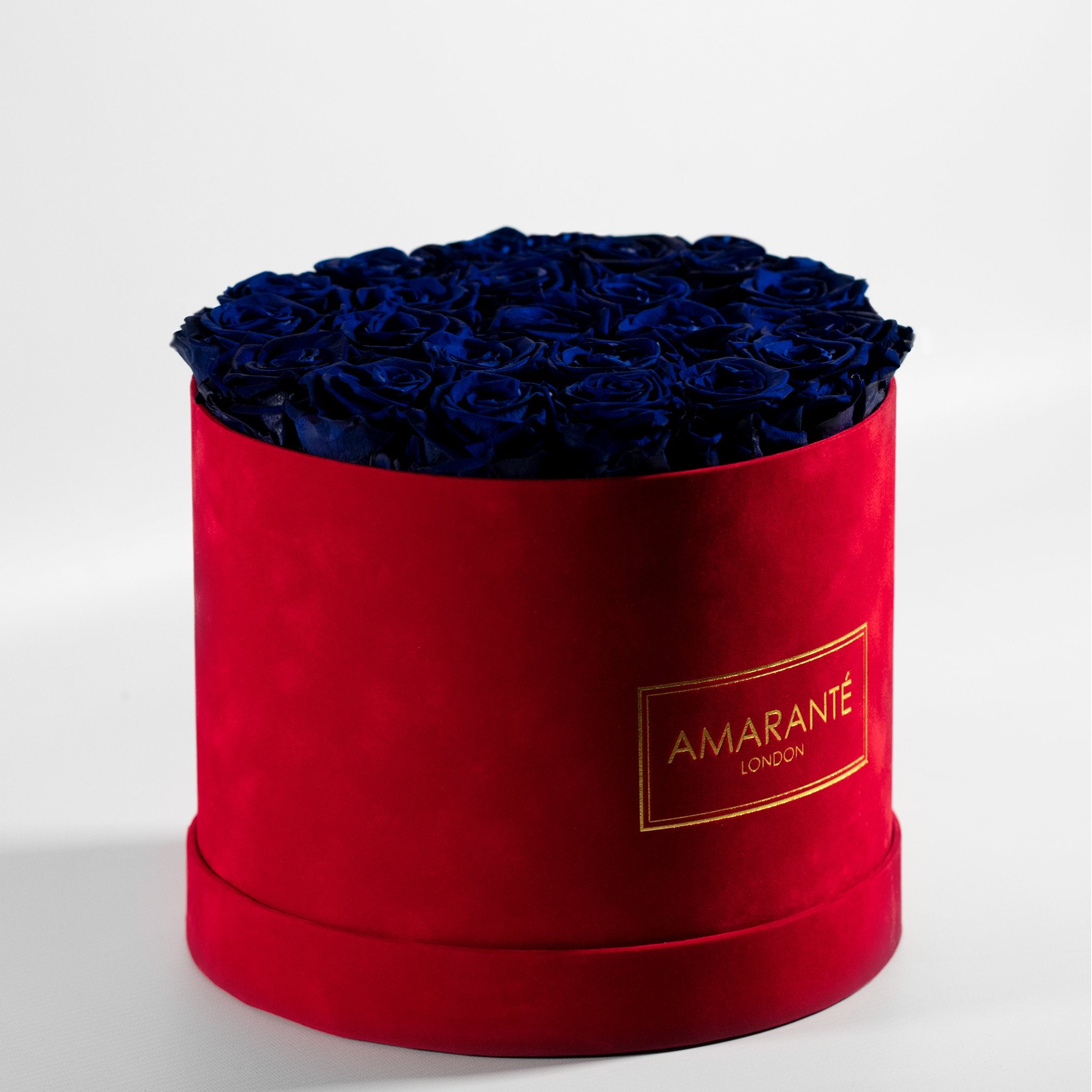 Luxurious royal purple Roses in a modish red box denoting protection and healing 