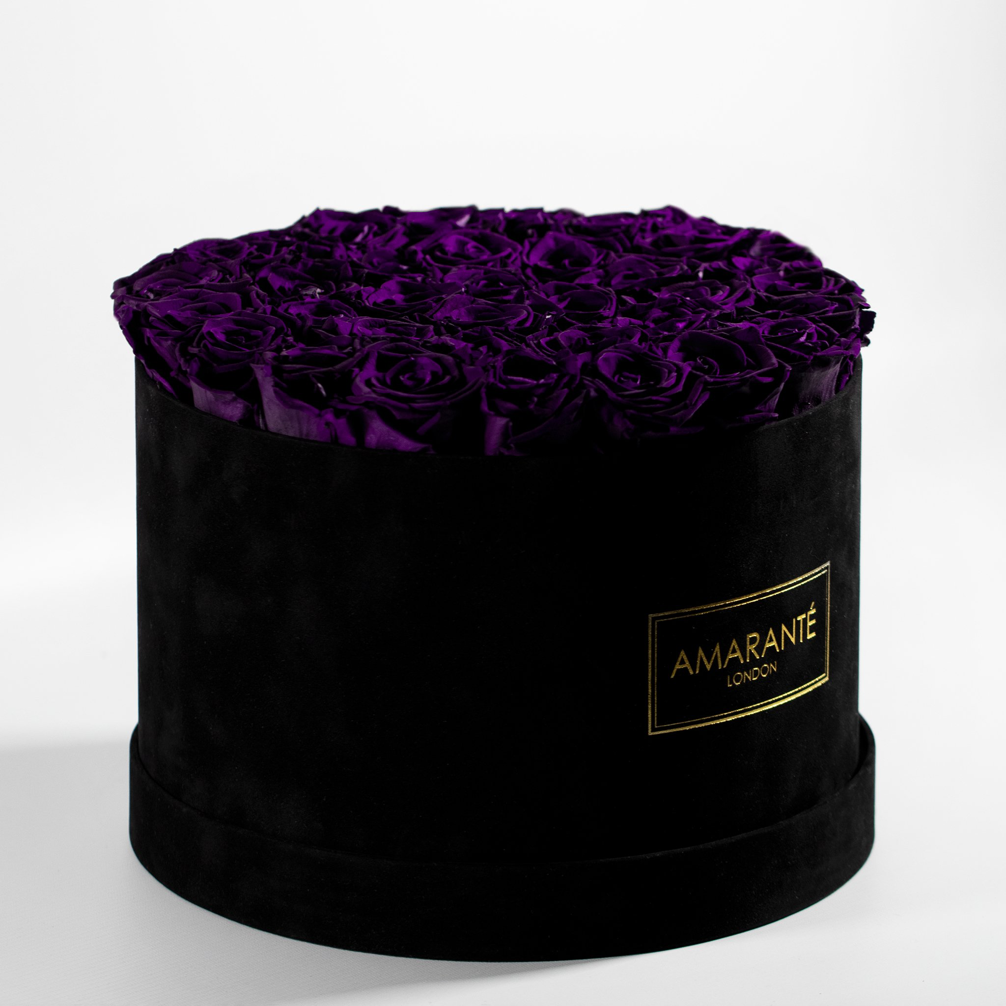 Dreamy dark purple Roses displayed in a stylish black circular box 