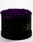 Dreamy dark purple Roses displayed in a stylish black circular box 