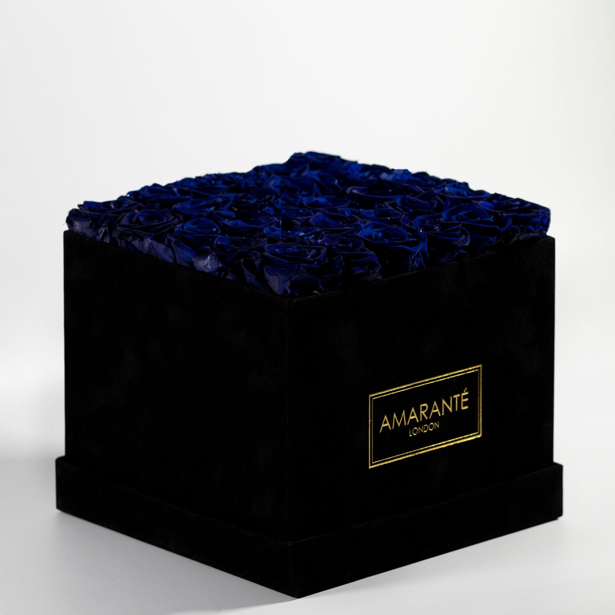 Divine royal blue Roses imbedded perfectly in a dapper black box 