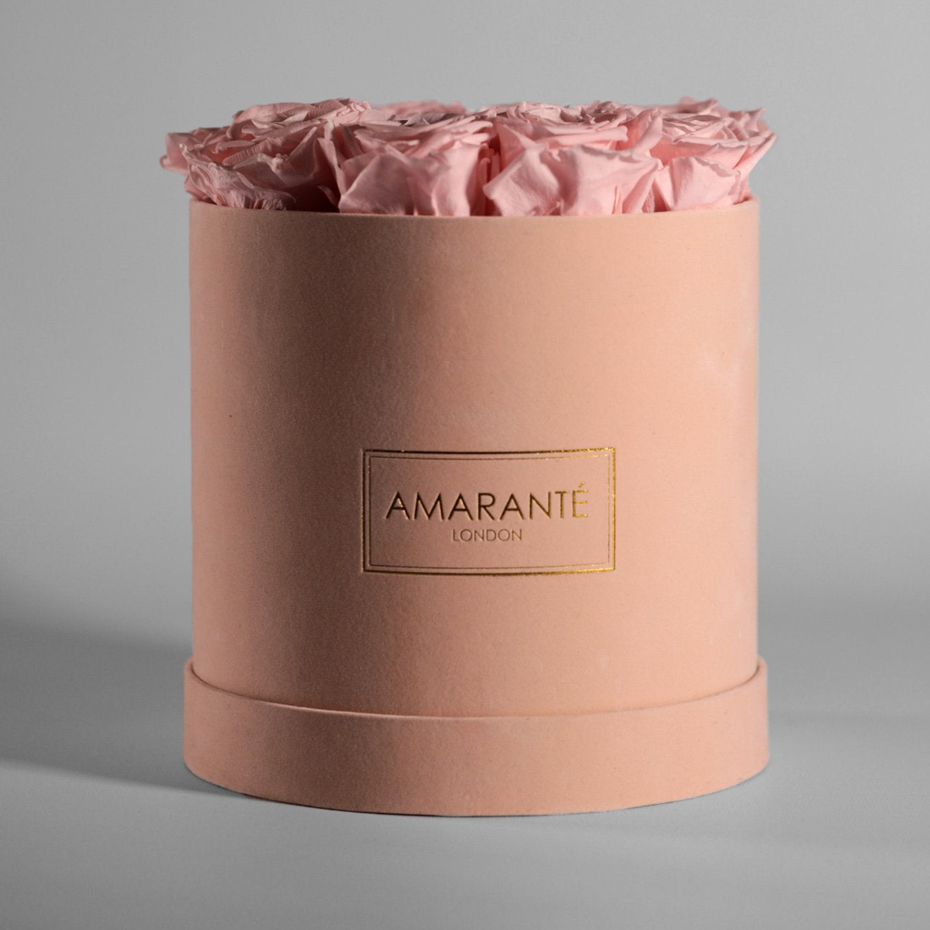 Blushing light pink roses encompassed in a stunning beige box. 